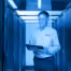 Hamilton Tech standing in the data center looking at an Ipad