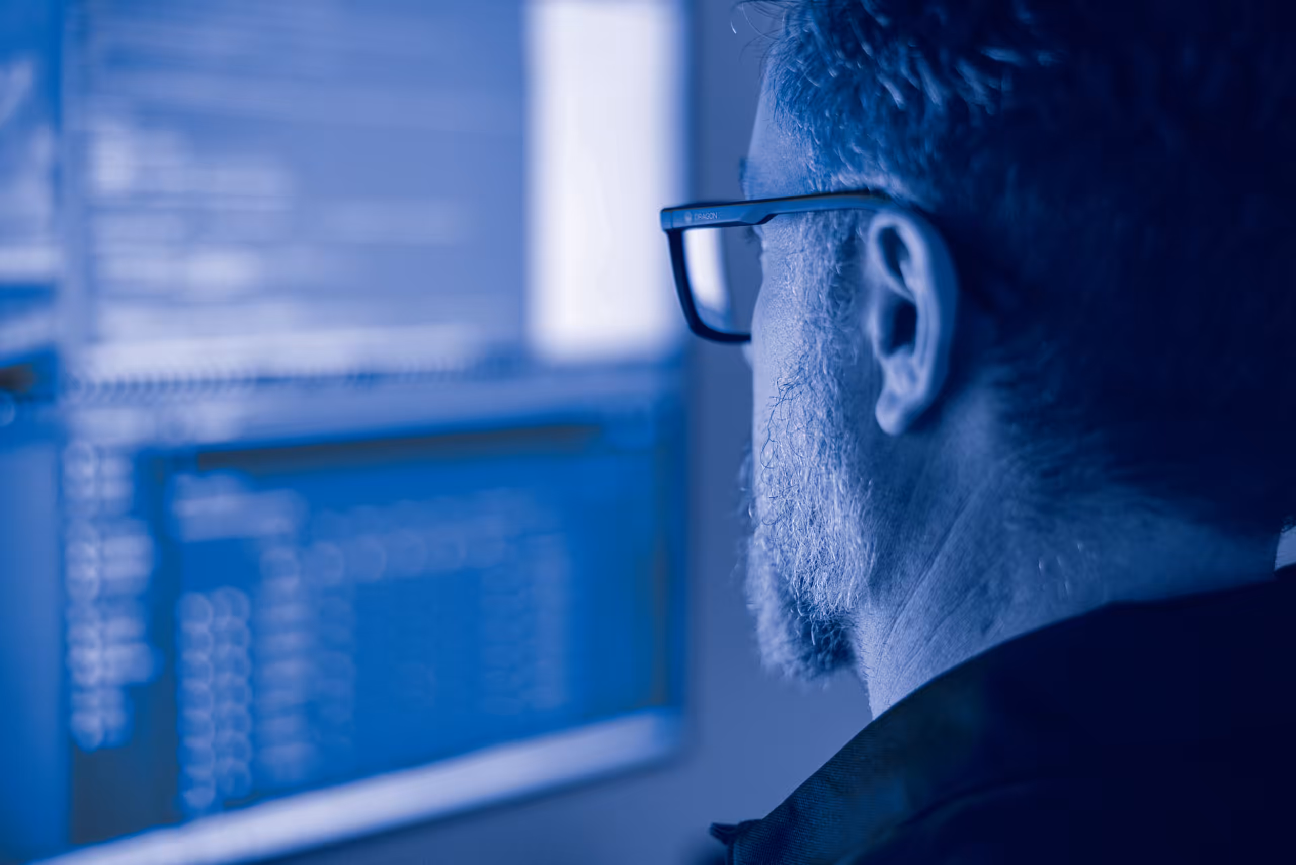 hamilton tech looking at a cybersecurity dashboard on a computer screen