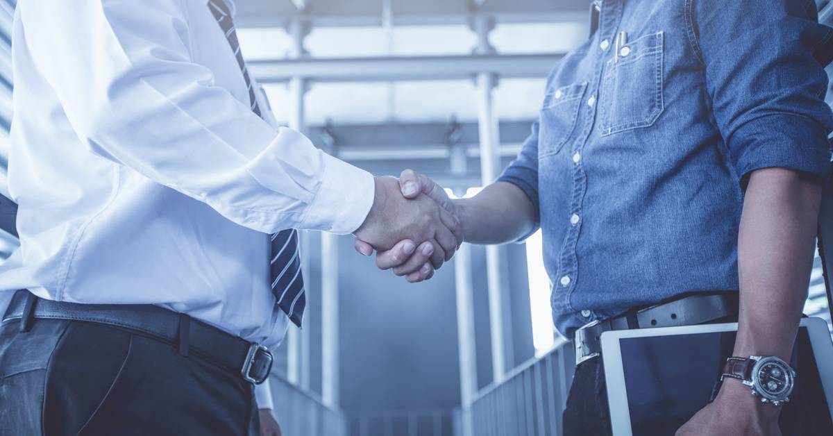 Business audit in server room. Business associates handshake.