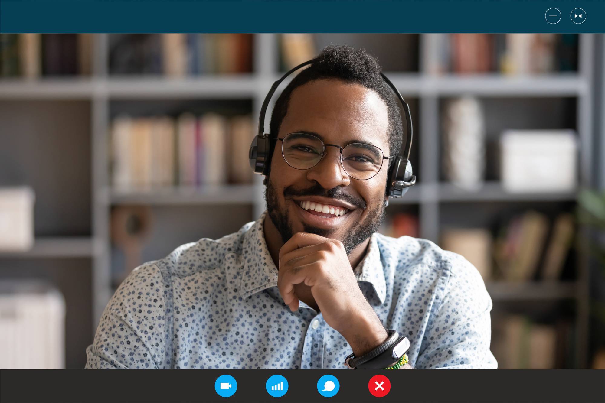 Man with headphones shown on monitor attending a virtual meeting.