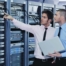 IT engineers in network server room solving problems and give co-managed IT help and support.