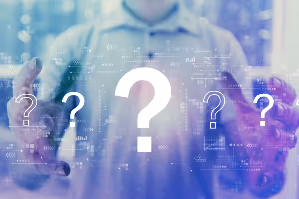 Question marks with young man holding his hands