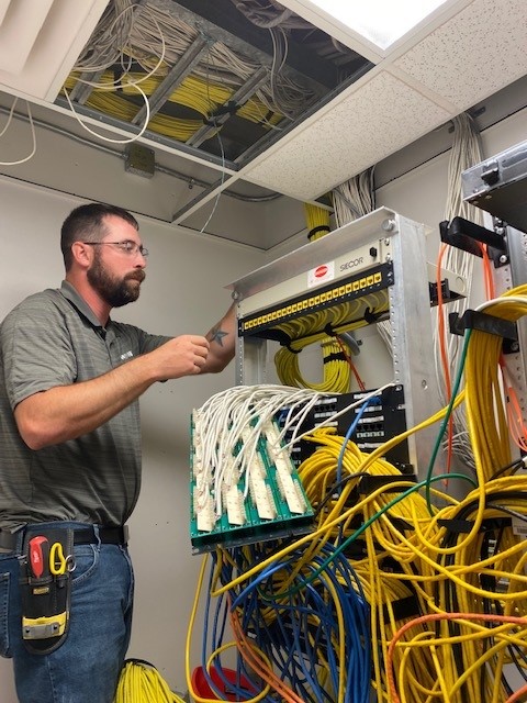 Hamilton Technician installing network cabling
