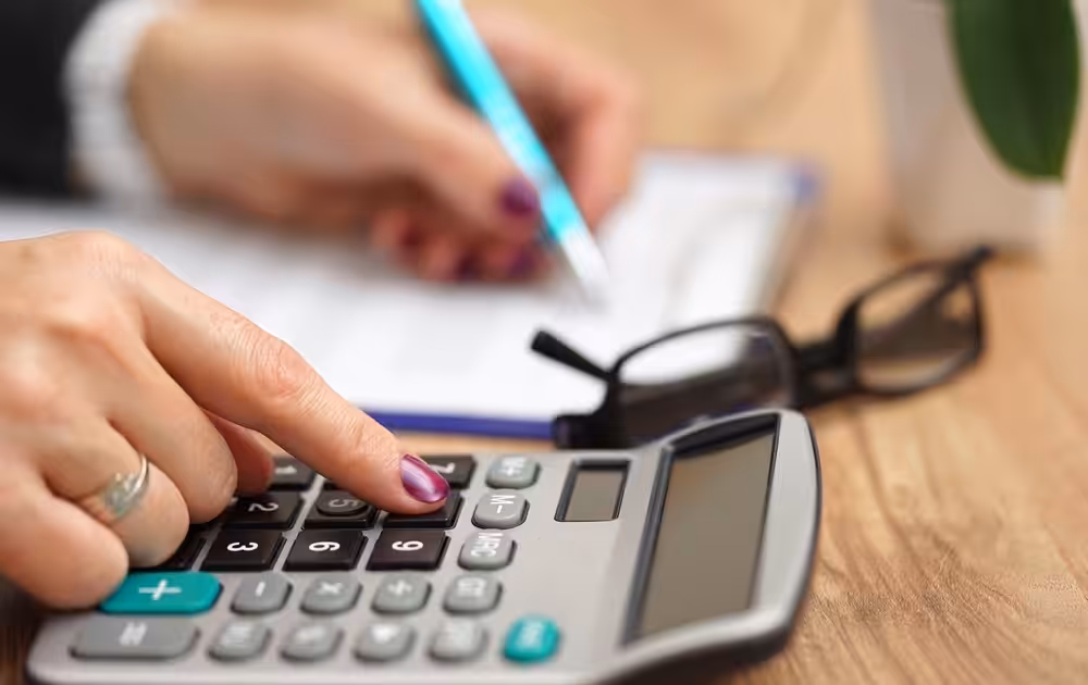Business woman calculating fees for Managed IT for her business.