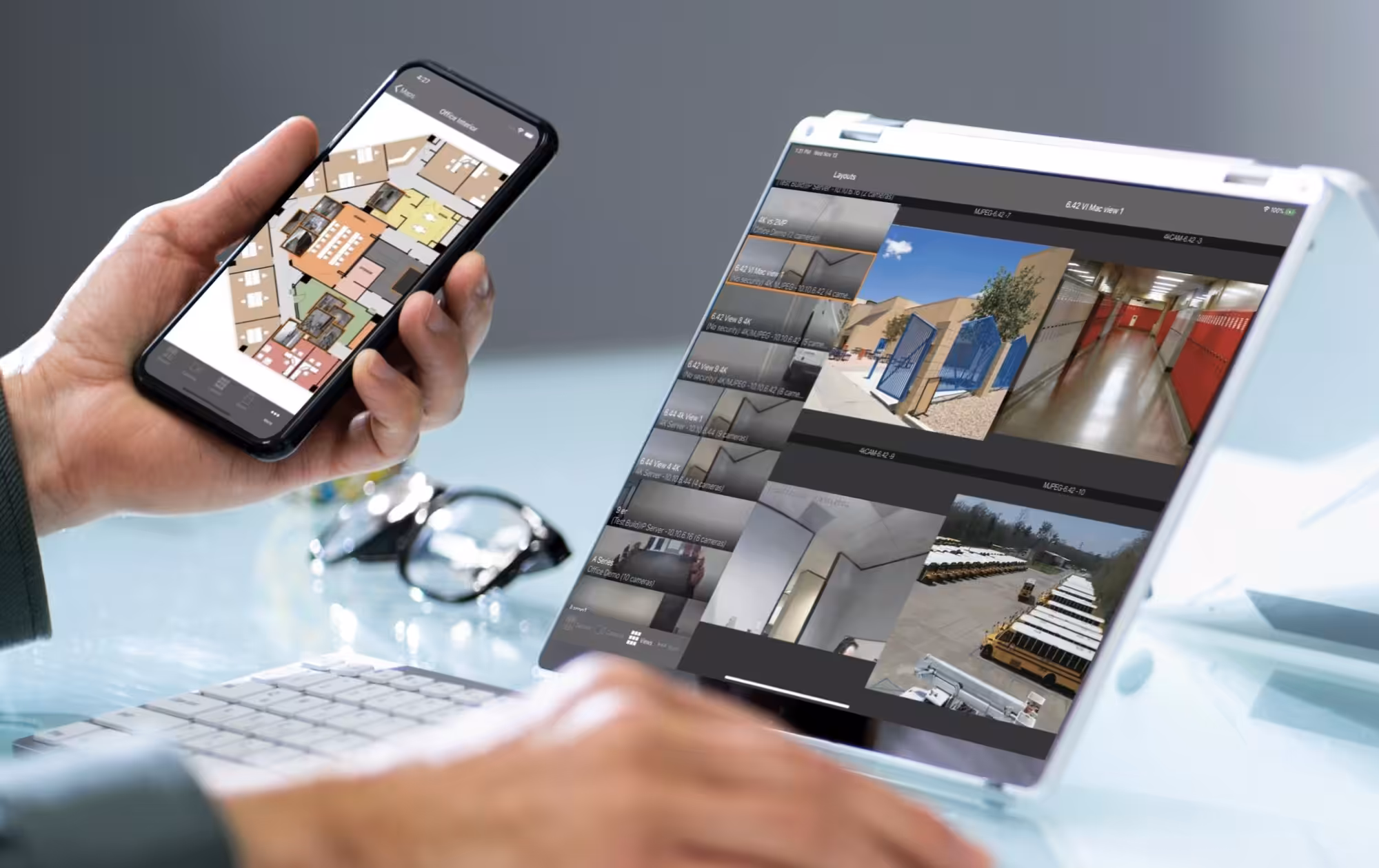 holding phone viewing remote security system
