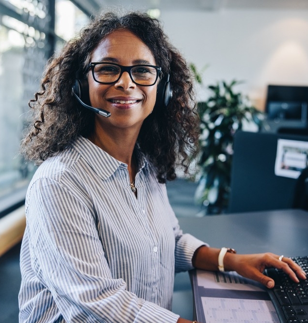 Portrait,Of,A,Confident,Female,Executive,Wearing,Headset,Sitting,In