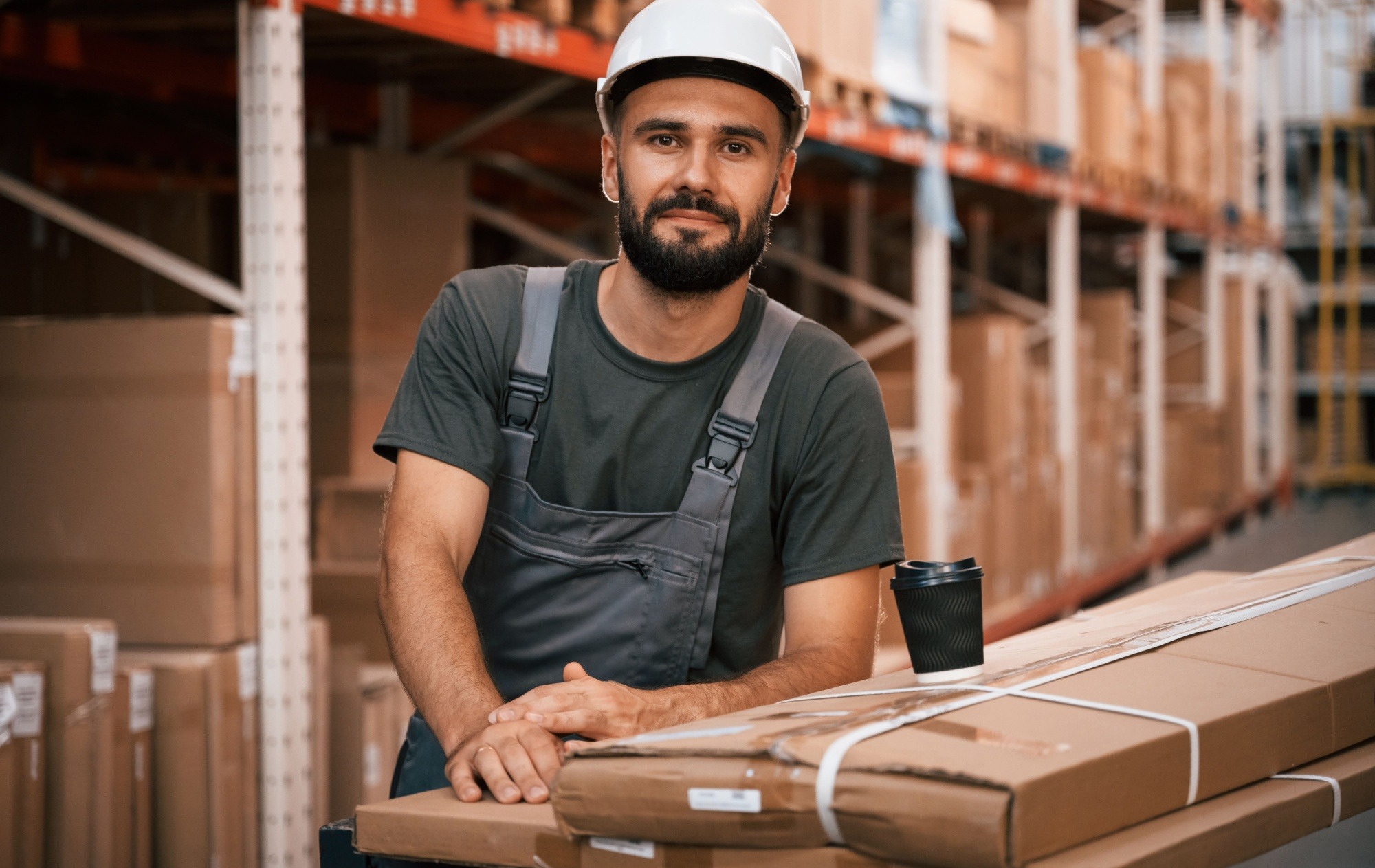 In white hard hat. Foreman is in the storehouse, shipping distribution business.