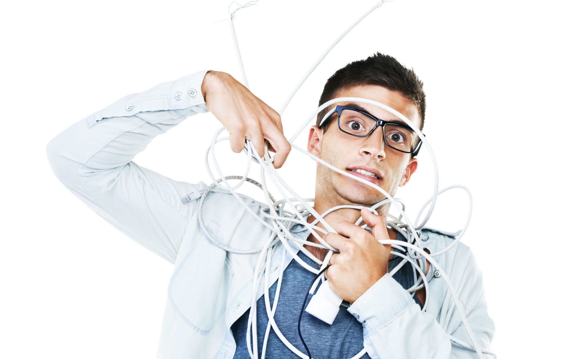 Portrait of man in glasses tangled in wire, cables and isolated on a white background.