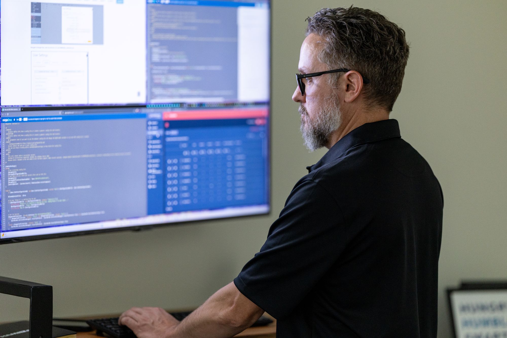 Hamilton Business Technologies employee reviewing computer files security.