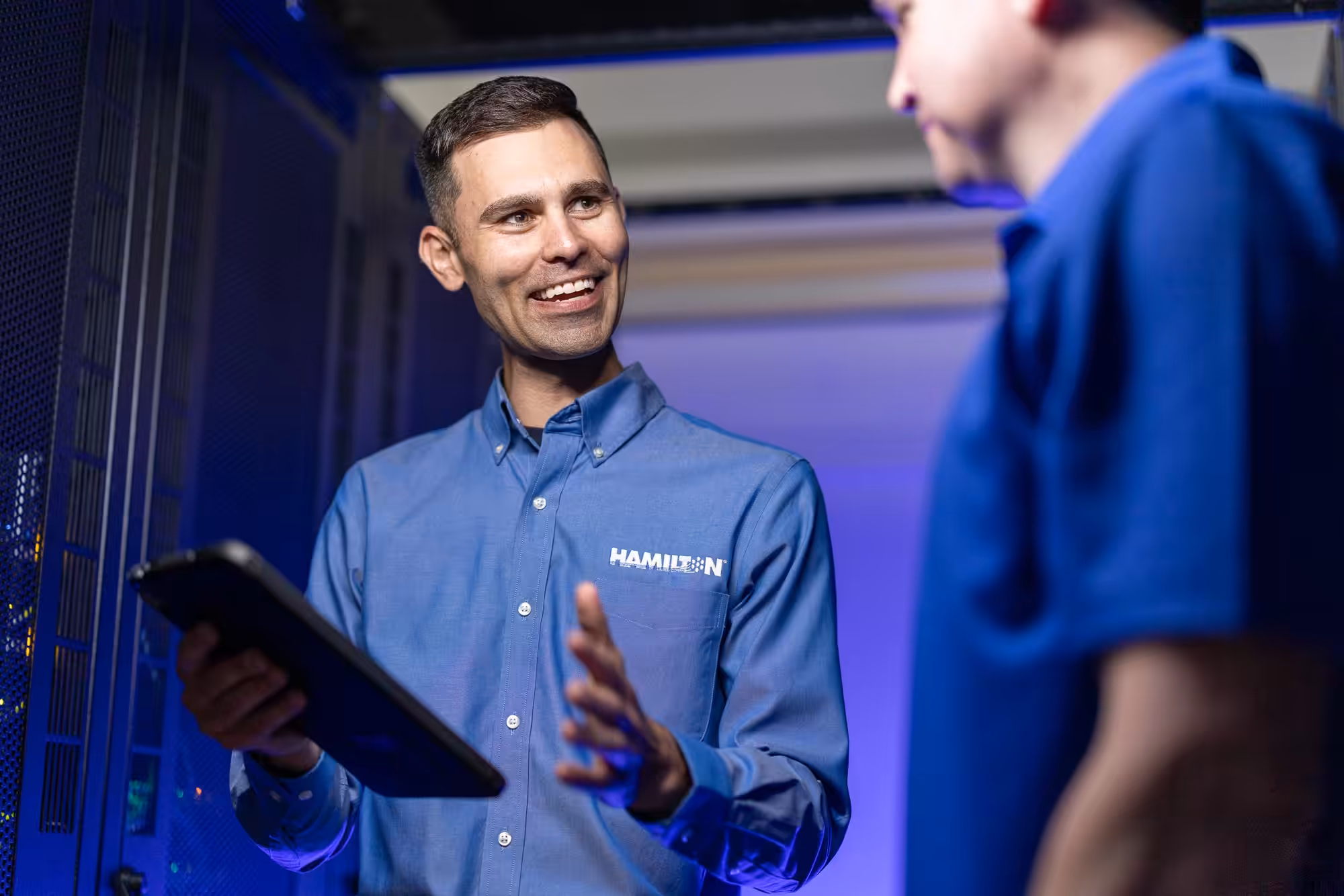 Hamilton Employee inside of data center talking with a client