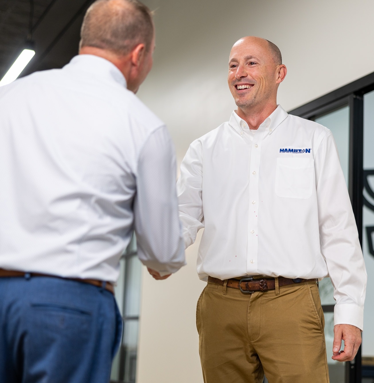 hamilton employee shaking hands with a client