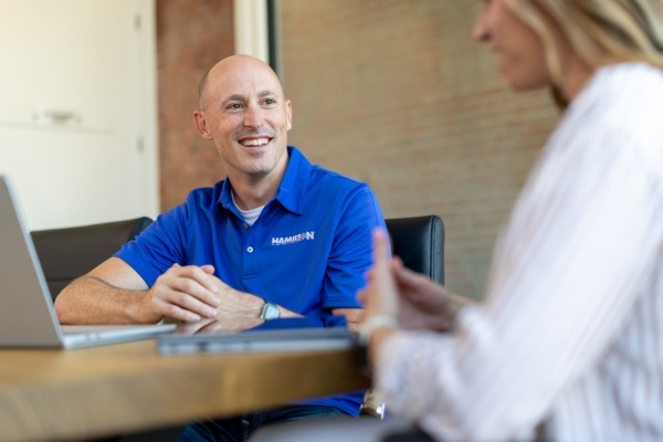 Hamilton tech working on a large screen, providing cybersecurity solutions.