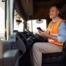 Driver takes order updates from the office on his mobile phone which is why business phone systems matter more than ever in today's digital age.