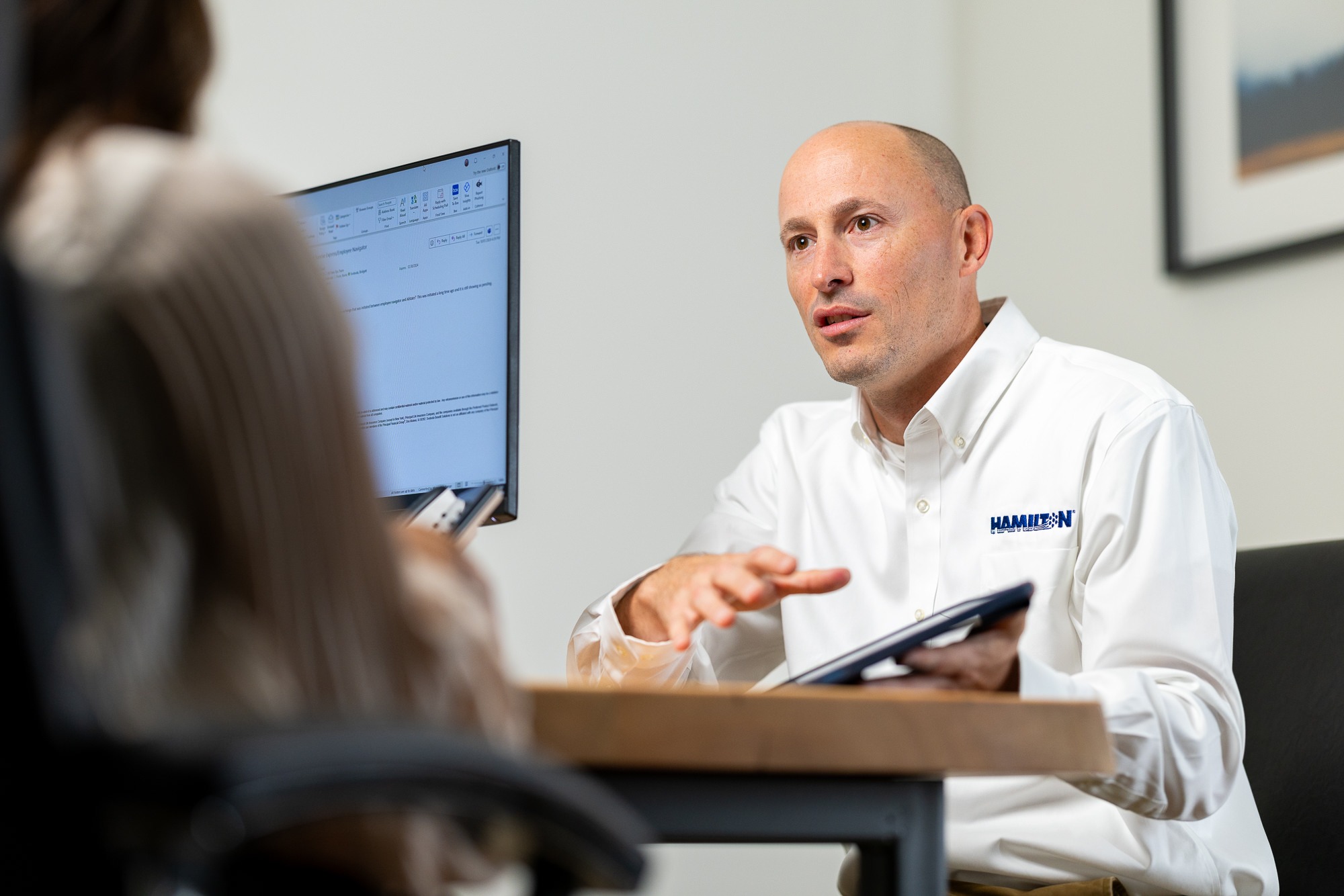 Hamilton sales rep meeting with a client showing potential IT consulting solutions
