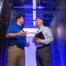 2 hamilton techs standing in the Hamilton Data center managing the network