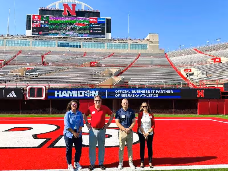 Hamilton employees, standing in memorial stadium in lincoln nebraska. Hamilton employees, standing in memorial stadium in lincoln nebraska.