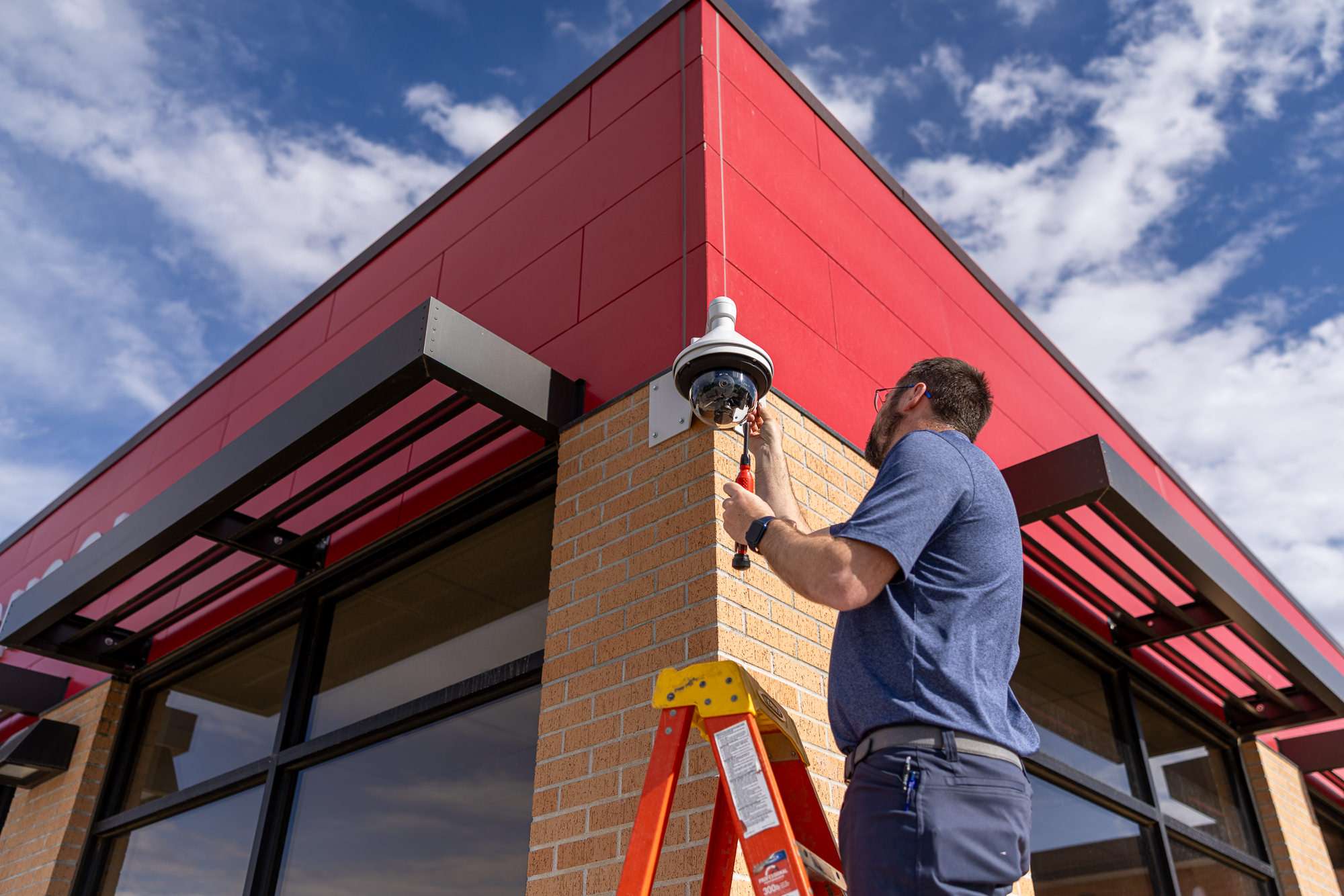 Hamilton Tech installing a security camera