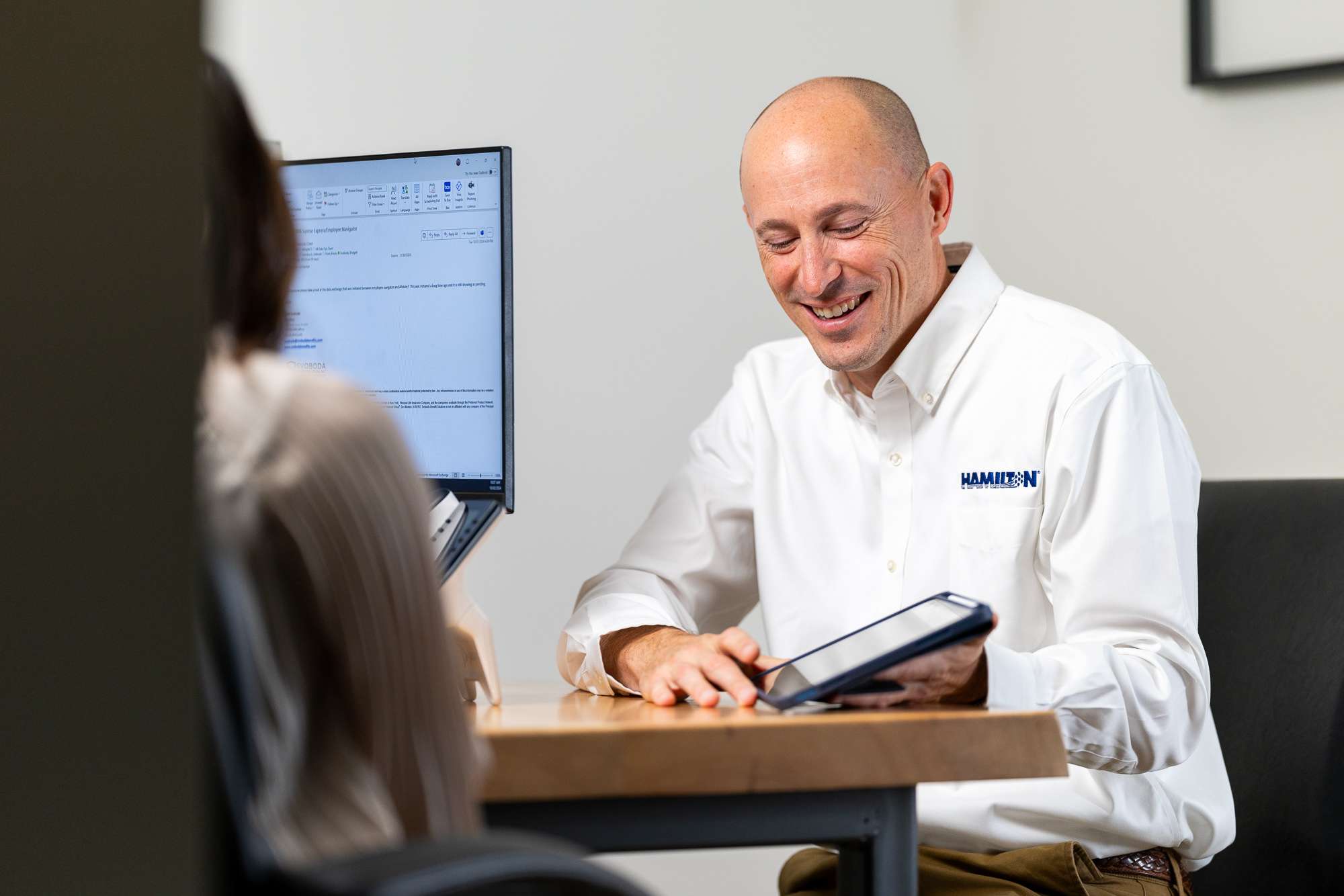 Hamilton Salesman displaying Hamilton's Managed IT solutions on an ipad