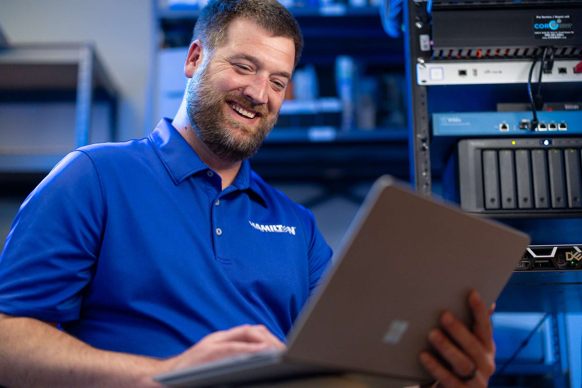 Hamilton Tech working on a computer in a server room