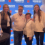 Hamilton CEO John Nelson and his wife standing with 2 Nebraska Volleyball players at an event