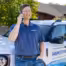 Hamilton sales man talking on the phone leaning agains a hamilton ford bronco
